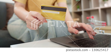 Cyber Monday Online Shopping. Woman with credit card making purchases on laptop. 130625417