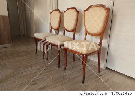 Renewal of old vintage furniture. Chairs and white covers. Interior design in apartment. Renewal of old vintage furniture. Chairs and white covers. Interior design in apartment. 130625480