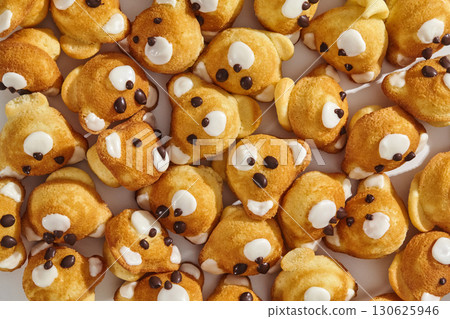 Cute bear-shaped muffins forming a delightful pattern, perfect for a children's party Cute bear-shaped muffins forming a delightful pattern, perfect for a children's party 130625946