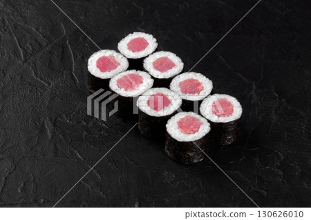 Eight maguro hosomaki sushi rolls with tuna filling on black background Eight maguro hosomaki sushi rolls with tuna filling on black background 130626010