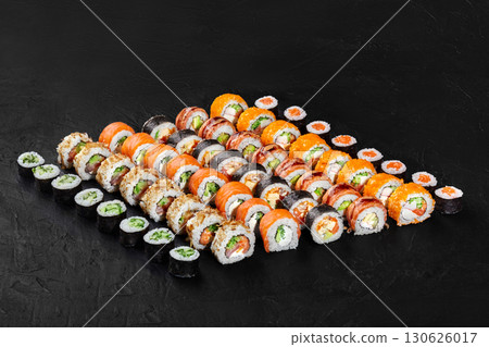 Large sushi set forming a triangle on a black background 130626017