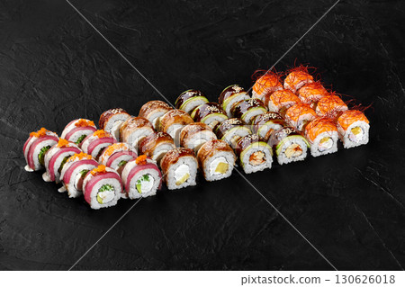 Delicious sushi rolls set displayed on black background Delicious sushi rolls set displayed on black background 130626018