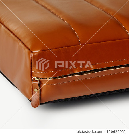 Close up of zipper on brown leather cushion showing stitching Close up of zipper on brown leather cushion showing stitching 130626031