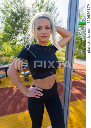 Young woman in athletic attire enjoying an outdoor fitness activity 130626179