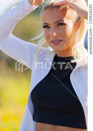 Athletic woman outdoors wearing sporty attire in a sunlight setting Athletic woman outdoors wearing sporty attire in a sunlight setting 130626185