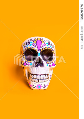 Painted skull for mexican Dia De Los Muertos holiday on orange background 130626470