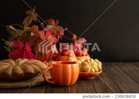 Autumn Composition with Pumpkin Mug, Bundt Cake and Seasonal Decor 130626650