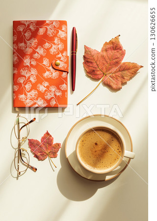 Autumn Flat Lay with Notebook, Coffee, Leaves and Eyeglasses under Sun Light Autumn Flat Lay with Notebook, Coffee, Leaves and Eyeglasses under Sun Light 130626655