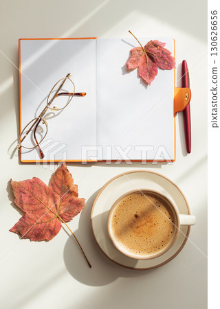 Autumn Flat Lay with Notebook, Coffee, Leaves and Eyeglasses under Sun Light 130626656