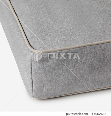 Corner of gray mattress with beige piping detailing on white background 130626659