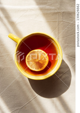 Flat Lay with Lemon Tea on Light Table under Sun Light Flat Lay with Lemon Tea on Light Table under Sun Light 130626662