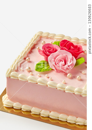 Delicious pink square cake decorated with icing roses and pearls Delicious pink square cake decorated with icing roses and pearls 130626683