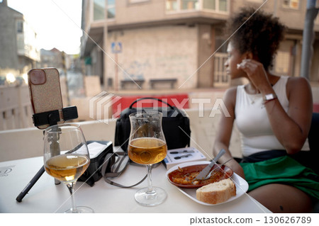 Woman drinking on urban terrace Woman drinking on urban terrace 130626789