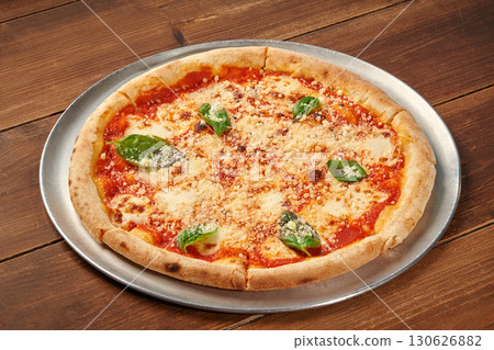 Delicious pizza margherita resting on wooden table Delicious pizza margherita resting on wooden table 130626882