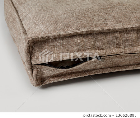 Close-up of zipper on beige linen cushion cover showing high-quality manufacturing Close-up of zipper on beige linen cushion cover showing high-quality manufacturing 130626893