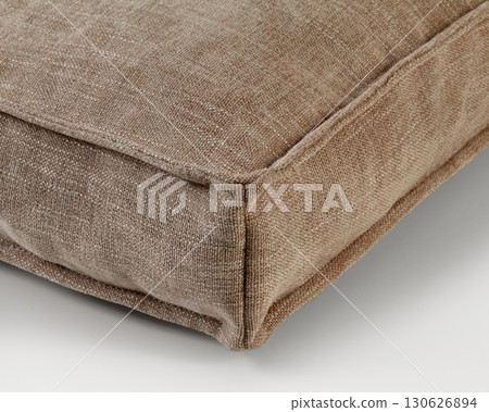 Close-up of beige fabric cushion corner showing stitching detail Close-up of beige fabric cushion corner showing stitching detail 130626894