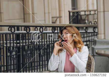 Woman Phone Call Outdoor Cafe Surprised Expression 130627192