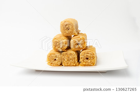 Rolled Baklava Isolated, Ramadan Dessert Roll on Restaurant Plate, Eastern Sweet Pastries 130627265