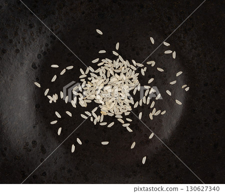 White parboiled rice grains. Dry uncooked ponni rice, small organic basmati White parboiled rice grains. Dry uncooked ponni rice, small organic basmati 130627340