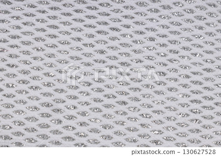 Close up of white mesh fabric with silver detail Close up of white mesh fabric with silver detail 130627528