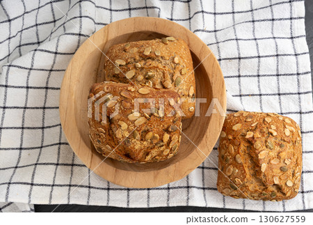 Pumpkin seeds bread, breakfast roll with pepita seeds. Fitness square bun, healthy burger Pumpkin seeds bread, breakfast roll with pepita seeds. Fitness square bun, healthy burger 130627559