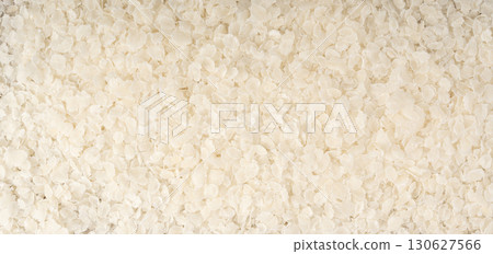 Raw flattened rice textured background. Dry rice flakes or poha pattern, Indian breakfast food 130627566