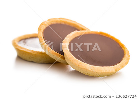 Sweet chocolate tartelettes isolated on white background. 130627724