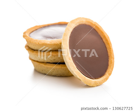 Sweet chocolate tartelettes isolated on white background. 130627725