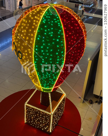 Large balloon sculpture with glowing lights placed in shopping mall. Public decoration, festive installation and entertainment culture with creative display and holiday atmosphere. 130627969