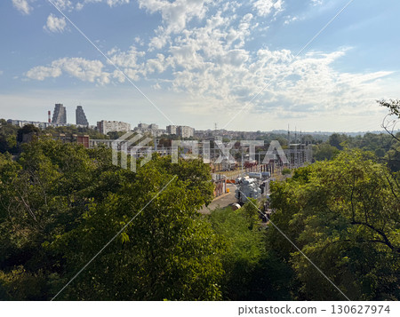 Electric substation with transformers and grid infrastructure near city. Industrial facility, energy distribution and urban development with power supply and engineering process. Electric substation with transformers and grid infrastructure near city. Industrial facility, energy distribution and urban development with power supply and engineering process. 130627974