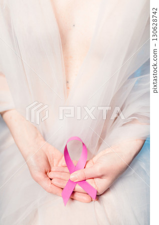 White Light Surrounding The Hands Of A Woman Fighting Cancer  130628742