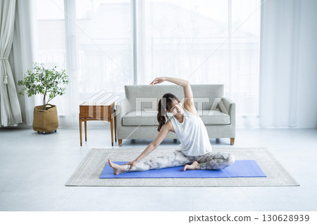 Young woman training at home 130628939