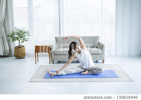 Young woman training at home Young woman training at home 130628940