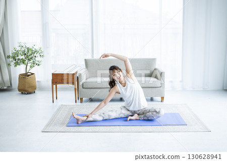 Young woman training at home Young woman training at home 130628941