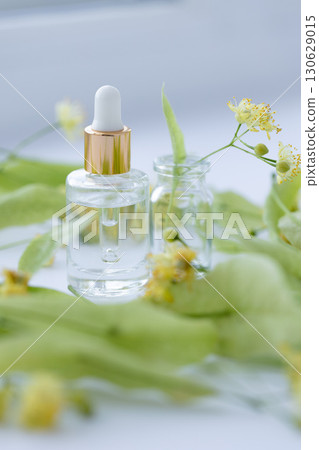 Linden extract in a small glass bottle. Selective focus. 130629015