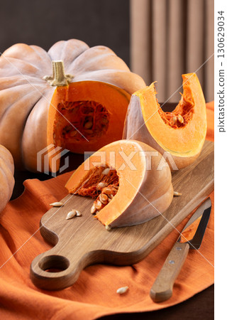 Cut Musquee De Provence Pumpkin On Kitchen Table Cut Musquee De Provence Pumpkin On Kitchen Table 130629034