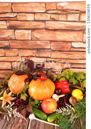 Autumn background with seasonal berries, pumpkins, apples, tomatoes and flowers of autumn nature on wooden boards, copy space, flat lay. Happy Thanksgiving concept, selective focus. 130629059