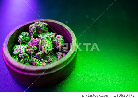 Colorful Cannabis Buds in a Wooden Bowl Colorful Cannabis Buds in a Wooden Bowl 130629472