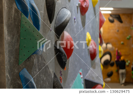 Artificial rock climbing wall with various 130629475