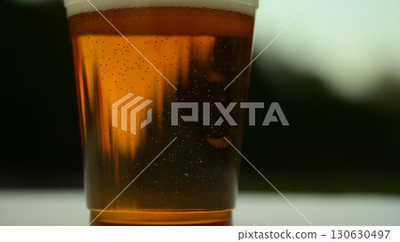 Beer poured into a plastic cup 130630497