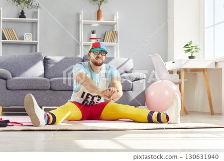 Funny Man In Colorful Outfit Stretching During Home Workout Funny Man In Colorful Outfit Stretching During Home Workout 130631940