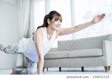 Young woman training at home 130632314