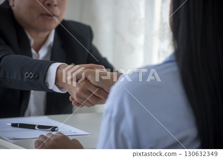 Team Business Partners shaking hands together to Greeting Start up new project. Shakehand Teamwork Partnership outside office modern city background. Businessman handshake together.  Business concept 130632349