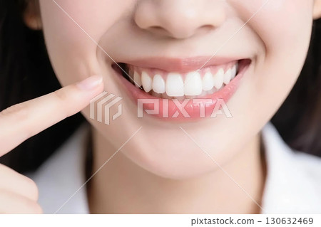 A woman pointing to a tooth A woman pointing to a tooth 130632469