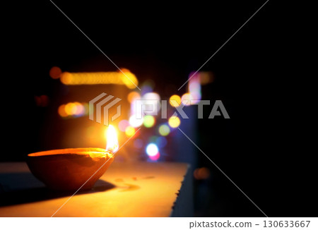 Traditional Clay Oil Lamp with Colorful Bokeh Lights at Night Traditional Clay Oil Lamp with Colorful Bokeh Lights at Night 130633667