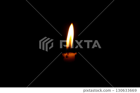 Burning Candle Flame in Darkness Symbolizing Light and Hope Burning Candle Flame in Darkness Symbolizing Light and Hope 130633669