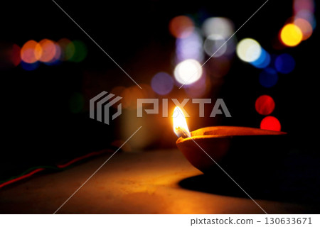Traditional Clay Oil Lamp with Colorful Bokeh Lights at Night Traditional Clay Oil Lamp with Colorful Bokeh Lights at Night 130633671