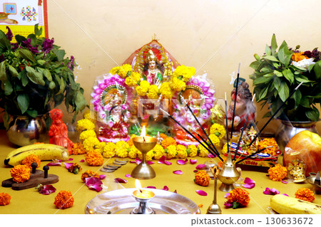 Traditional Hindu Festive Puja with Idols, Flowers, and Offering 130633672