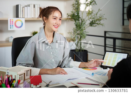 Interior Design Consultation: Smiling Designer Presenting Color Options 130633781
