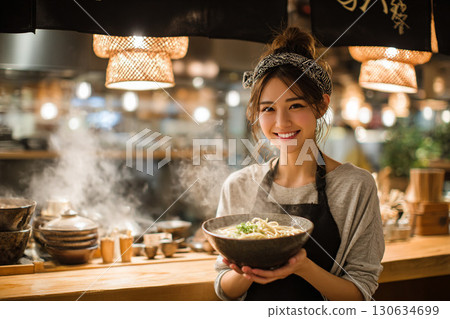 Female chef serving food in a modern Japanese restaurant 130634699